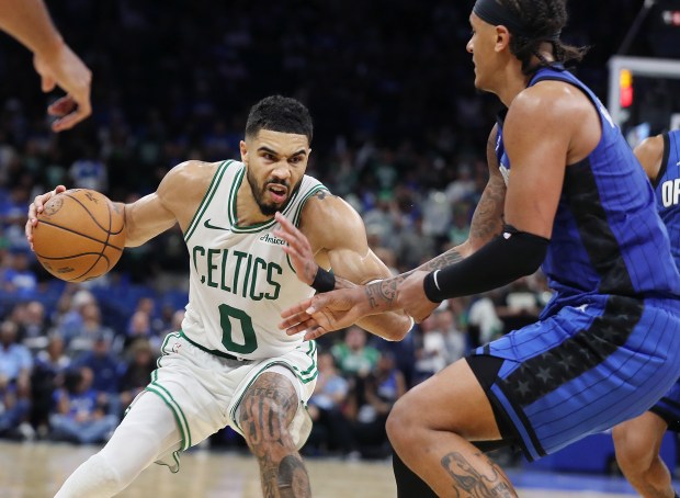 Boston forward Jayson Tatum (0) tries to get past Orlando...