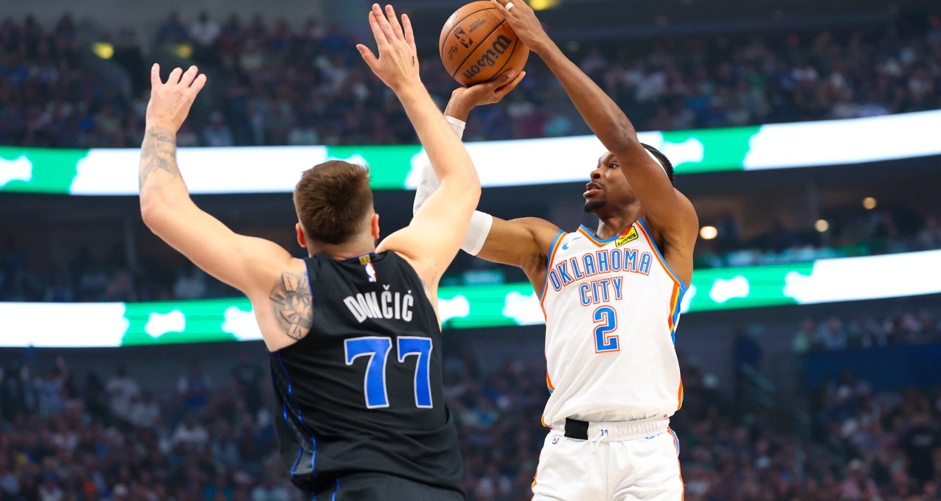 May 18, 2024; Dallas, Texas, USA; Oklahoma City Thunder guard Shai Gilgeous-Alexander (2) shoots over Dallas Mavericks guard Luka Doncic (77) during the first quarter in game six of the second round of the 2024 NBA playoffs at American Airlines Center. Mandatory Credit: Kevin Jairaj-USA TODAY Sports
