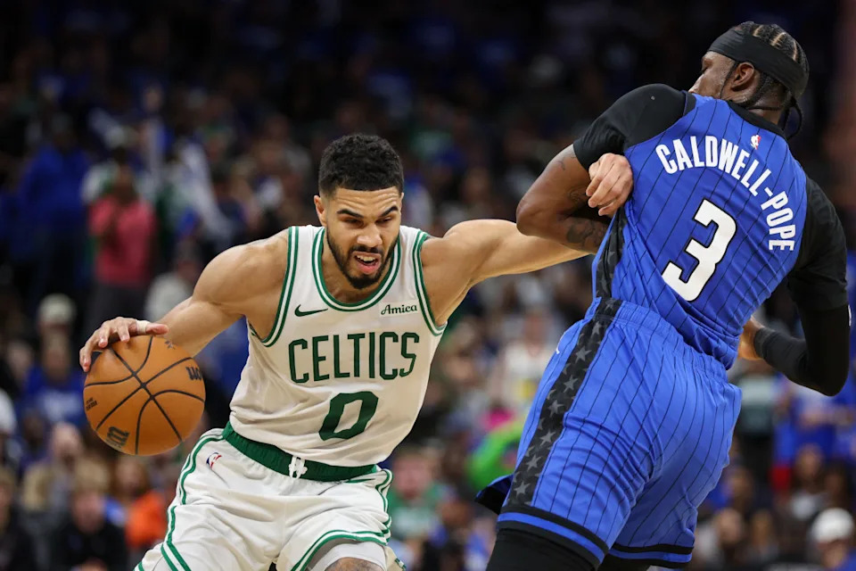 Boston Celtics forward Jayson Tatum (0) and Orlando Magic guard Kentavious Caldwell-Pope (3)Nathan Ray Seebeck-Imagn Images