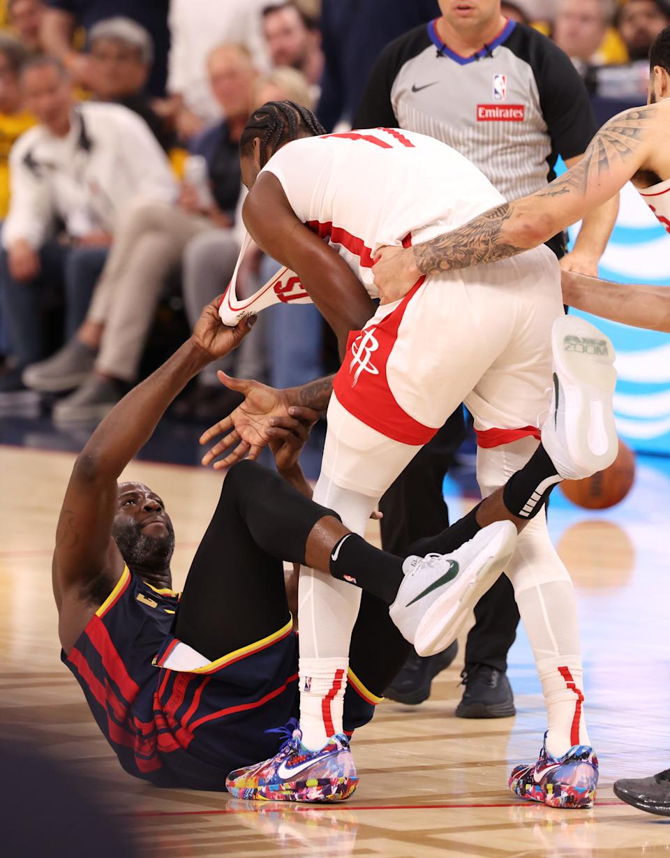 Warriors forward Draymond Green pulls on the jersey of Rockets forward Tari Eason during the second quarter of Game 4. Eason was called for a technical foul for his actions after the play.