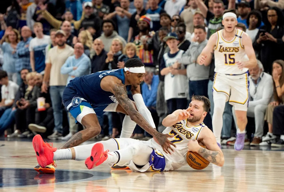Los Angeles Lakers guard Luka Doncic (77) calls a timeout after stumbling on the defense of Minnesota Timberwolves forward Jaden McDaniels (3) in the fourth quarter during game four of first round for the 2025 NBA Playoffs at Target Center. IMAGN IMAGES via Reuters Connect