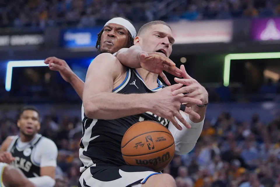 Milwaukee Bucks center Brook Lopez (11) and Indiana Pacers center Myles Turner (33) fight for a rebound during the first half of a first-round NBA basketball playoff game in Indianapolis, Tuesday, April 22, 2025. (AP Photo/Michael Conroy)