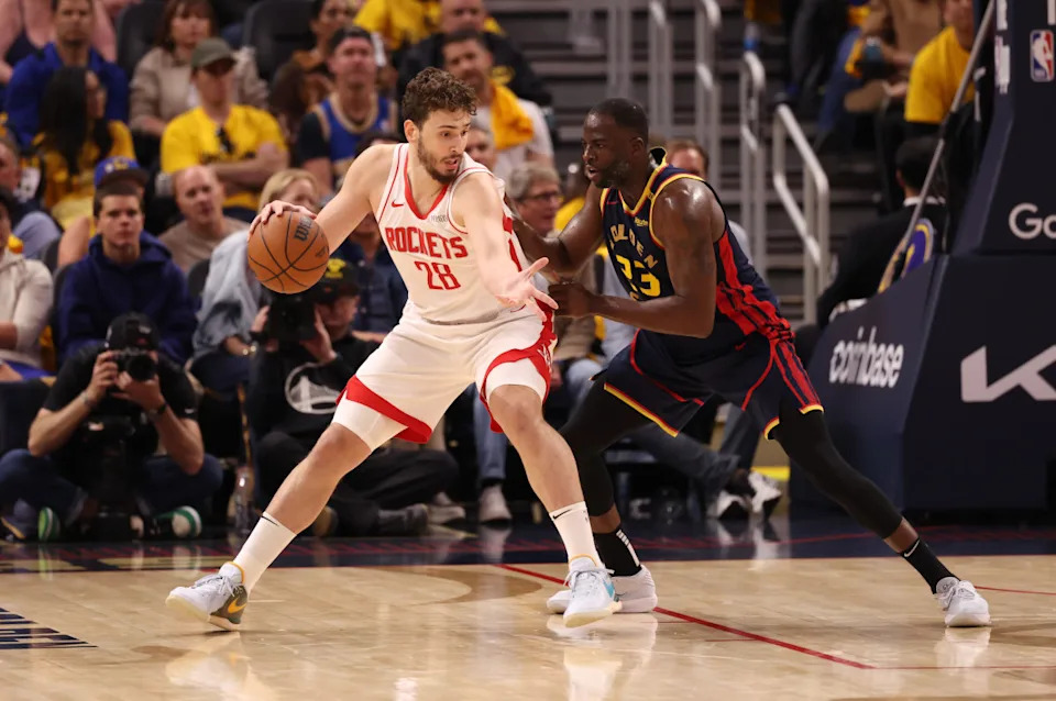 Houston Rockets center Alperen Sengun posts up against Golden State Warriors forward Draymond Green.Kelley L Cox-Imagn Images