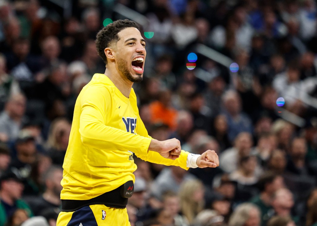 Tyrese Haliburton of the Indiana Pacers celebrates on the sidelines.