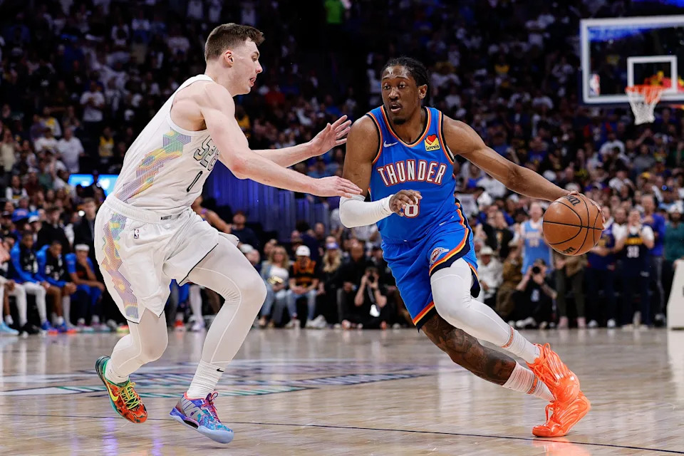 May 15, 2025; Denver, Colorado, USA; Oklahoma City Thunder forward Jalen Williams (8) controls the ball as Denver Nuggets guard Christian Braun (0) guards in the second quarter during game six of the second round for the 2025 NBA Playoffs at Ball Arena. Mandatory Credit: Isaiah J. Downing-Imagn Images