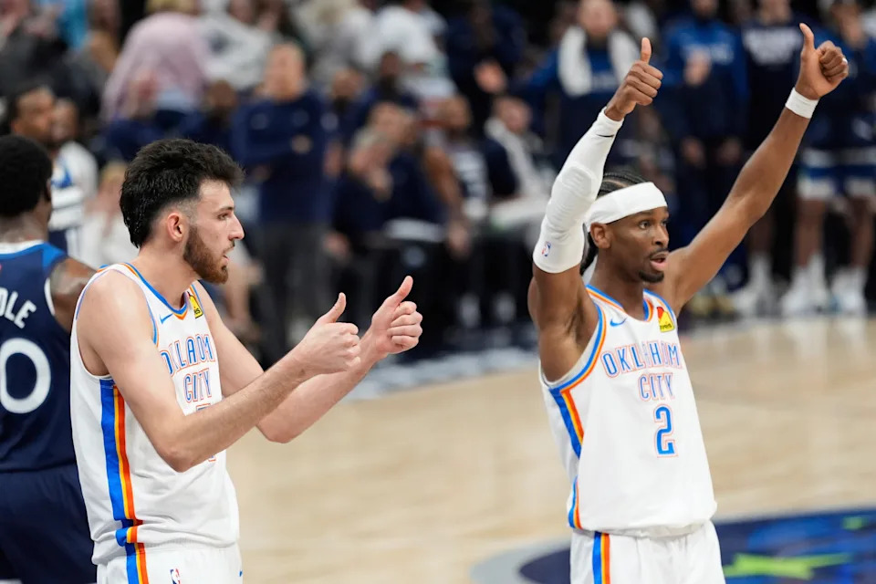 Oklahoma City Thunder forward Chet Holmgren, left, and guard Shai Gilgeous-Alexander (2) gesture during the first half of Game 4 of the Western Conference finals of the NBA basketball playoffs against the Minnesota Timberwolves Monday, May 26, 2025, in Minneapolis. (AP Photo/Abbie Parr)