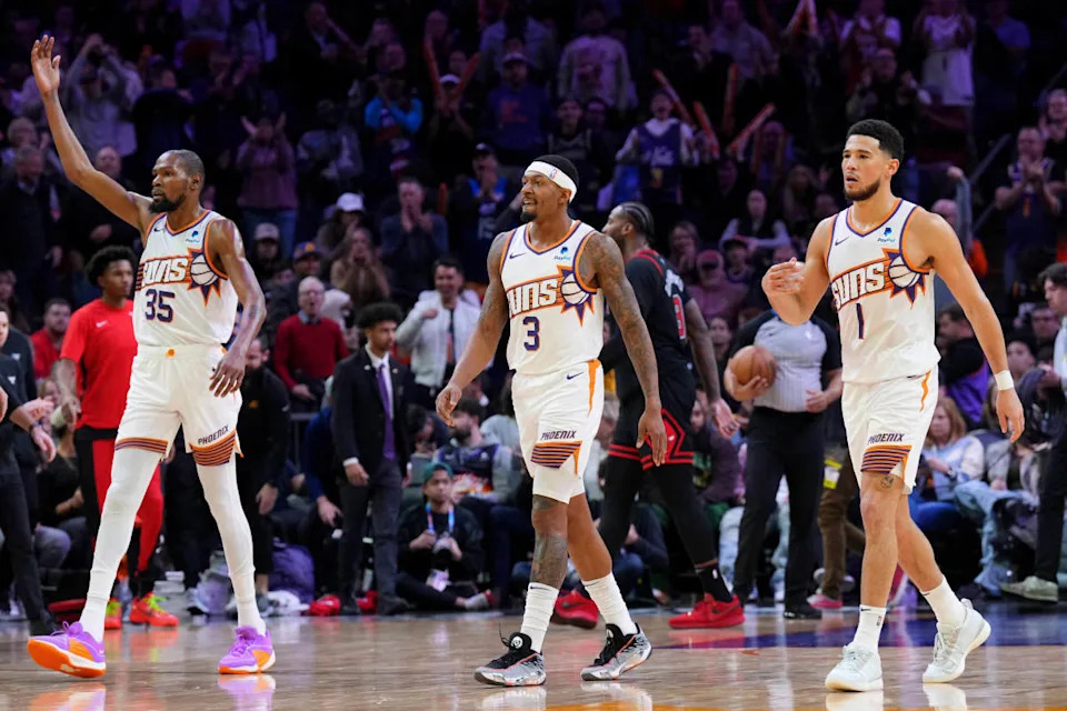 Phoenix Suns forward Kevin Durant (35) and Phoenix Suns guard Bradley Beal (3) and Phoenix Suns guard Devin Booker (1) reacts during the second half of the game against the Chicago Bulls at Footprint Center.Joe Camporeale-USA TODAY Sports