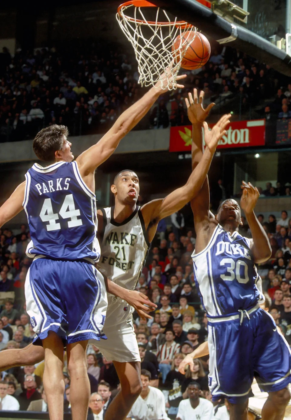Wake Forest Demon Deacons center Tim Duncan puts up a shot between Duke Blue Devils forward Cherokee Parks and Tony Moore.