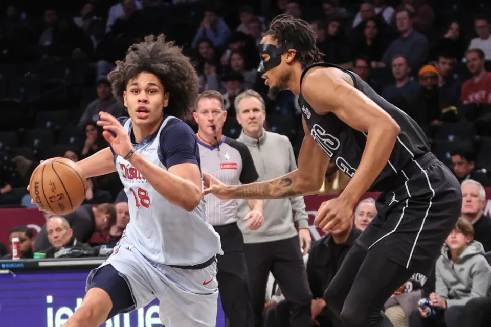 Feb 5, 2025; Brooklyn, New York, USA; Washington Wizards forward Kyshawn George (18) looks to drive past Brooklyn Nets center Nic Claxton (33) in the first quarter at Barclays Center. Mandatory Credit: Wendell Cruz-Imagn Images