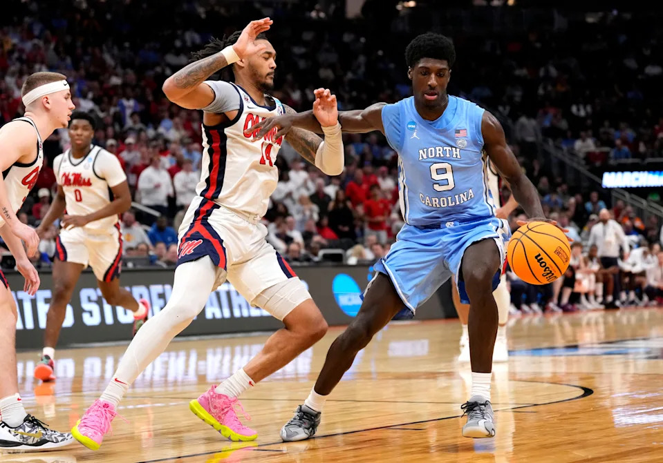 Mar 21, 2025; Milwaukee, WI, USA; North Carolina Tar Heels guard Drake Powell (9) drives against Mississippi Rebels guard Dre Davis (14) during the second half of a first round NCAA men’s tournament game at Fiserv Forum. Mandatory Credit: Jeff Hanisch-Imagn Images