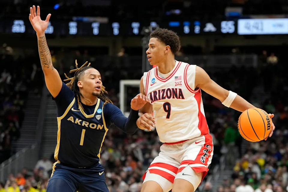Mar 21, 2025; Seattle, WA, USA; Arizona Wildcats forward Carter Bryant (9) dribbles the ball against Akron Zips guard Shammah Scott (1) during the second half in the first round of the NCAA Tournament at Climate Pledge Arena. Mandatory Credit: Stephen Brashear-Imagn Images