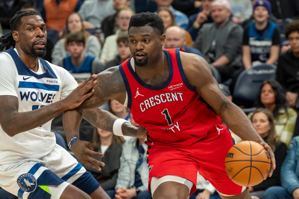 Pelicans forward Zion Williamson (1) drives to the basket past Minnesota Timberwolves center Naz Reid (11)