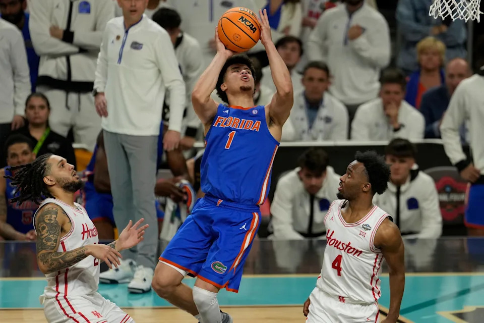 Apr 7, 2025; San Antonio, TX, USA; Florida Gators guard Walter Clayton Jr. (1) shoots the ball against Houston Cougars guard L.J. Cryer (4) during the second half in the national championship game of the Final Four of the 2025 NCAA Tournament at the Alamodome.Mandatory Credit: Scott Wachter-Imagn Images