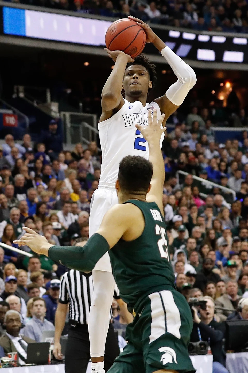 Duke Blue Devils forward Cam Reddish shootsover Michigan State Spartans forward Kenny Goins.