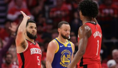 Fred VanVleet and Amen Thompson of the Houston Rockets high five in front of Golden State star Stephen Curry during the Rockets