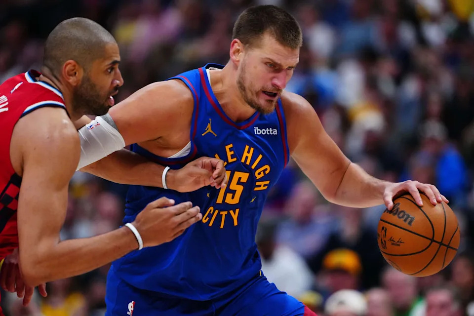 May 3, 2025; Denver, Colorado, USA; LA Clippers forward Nicolas Batum (33) defends on Denver Nuggets center Nikola Jokic (15) in the third quarter during game seven of first round for the 2025 NBA Playoffs at Ball Arena. Mandatory Credit: Ron Chenoy-Imagn Images