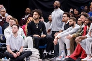 Injured Dallas Mavericks players watch as their teammates face the Minnesota Timberwolves on...