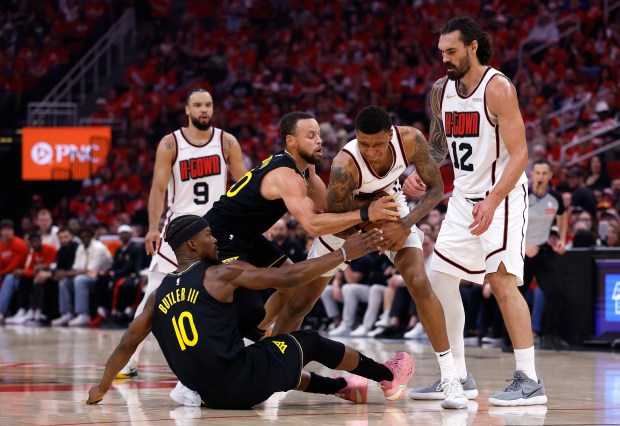 Jabari Smith Jr. #10 of the Houston Rockets battles for the ball against Stephen Curry #30 and Jimmy Butler III #10 of the Golden State Warriors during the second quarter in Game Seven of the Western Conference First Round NBA Playoffs at Toyota Center on May 04, 2025 in Houston, Texas. (Photo by Tim Warner/Getty Images)