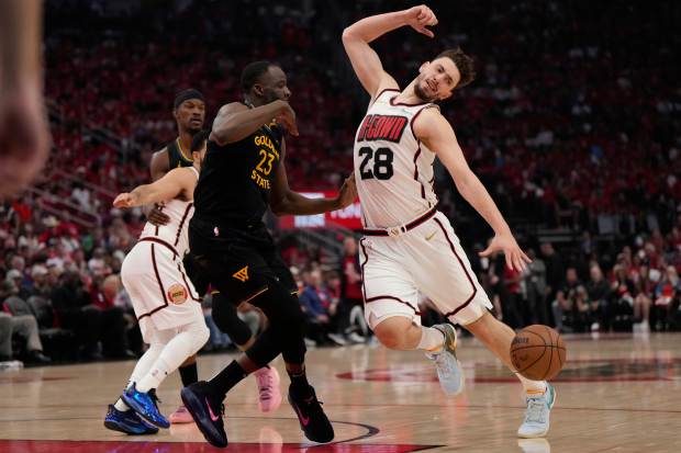 Houston Rockets' Alperen Sengun (28) is fouled by Golden State Warriors' Draymond Green (23) during the first half of Game 7 of an NBA basketball first-round playoff series Sunday, May 4, 2025, in Houston. (AP Photo/Ashley Landis)