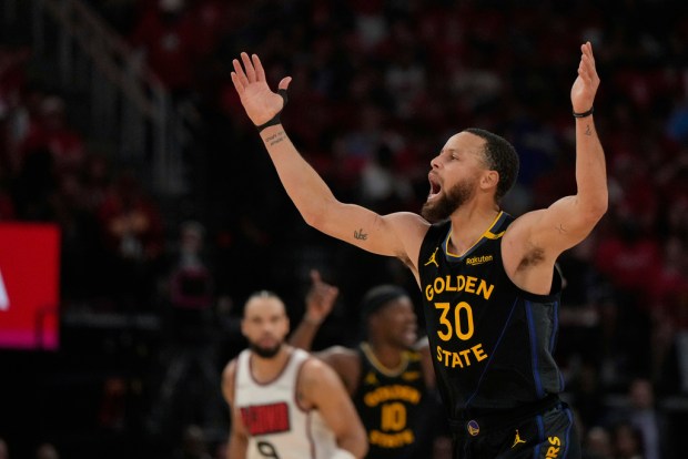 Golden State Warriors' Stephen Curry (30) celebrates after making a shot against the Houston Rockets during the first half of Game 7 of an NBA basketball first-round playoff series Sunday, May 4, 2025, in Houston. (AP Photo/Ashley Landis)