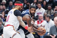 Golden State Warriors guard Gary Payton II (0) guards Dallas Mavericks guard Kyrie Irving...