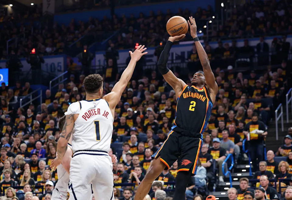 Thunder guard Shai Gilgeous-Alexander (2) shoots against Nuggets forward Michael Porter Jr. (1).Alonzo Adams-Imagn Images