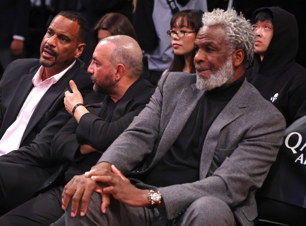 Charles Oakley (right) watches the Nets-Sun game at Barclays Center during the regular season.