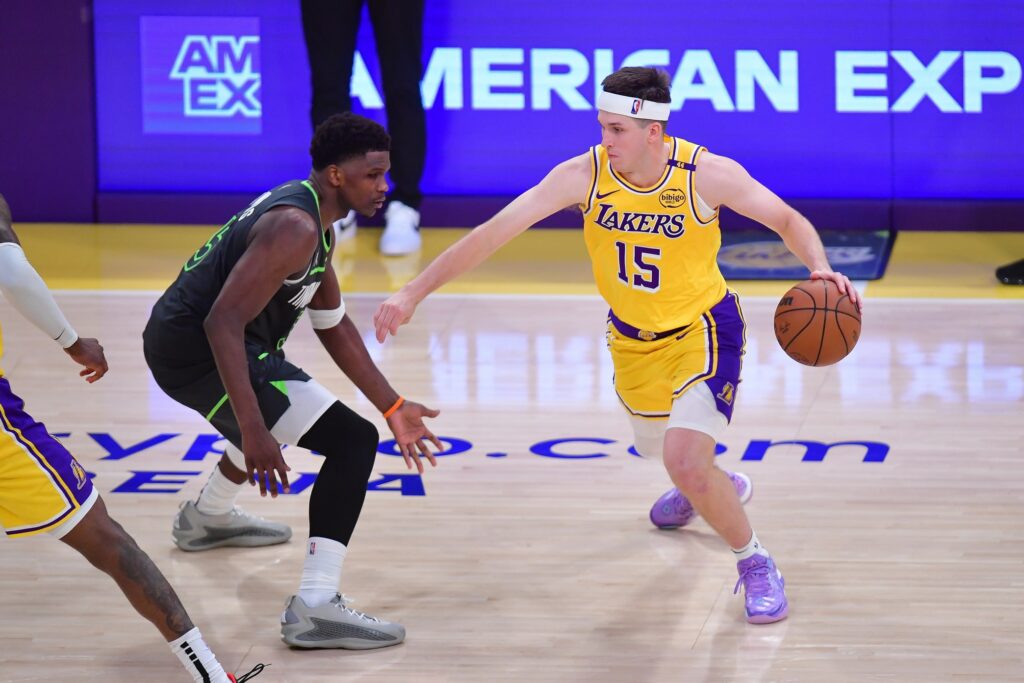 Apr 30, 2025; Los Angeles, California, USA; Los Angeles Lakers guard Austin Reaves (15) moves the ball against Minnesota Timberwolves guard Anthony Edwards (5) during the second half in game five of first round for the 2025 NBA Playoffs at Crypto.com Arena. Mandatory Credit: Gary A. Vasquez-Imagn Images