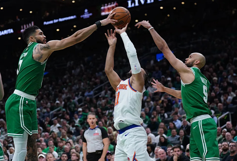 May 7, 2025; Boston, Massachusetts, USA; Boston Celtics forward Jayson Tatum (0) and guard Derrick White (9) defend against New York Knicks guard Jalen Brunson (11) in the second quarter during game two of the second round for the 2025 NBA Playoffs at TD Garden. Mandatory Credit: David Butler II-Imagn Images