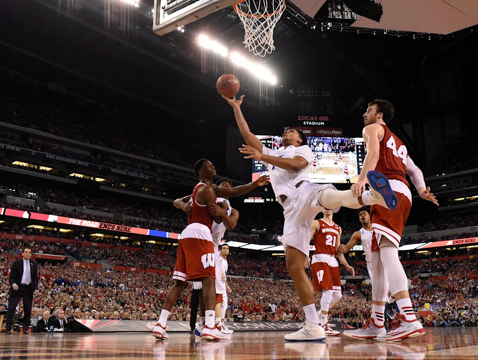 Duke Blue Devils center Jahlil Okafor puts up a shot after being fouled by Wisconsin Badgers forward Frank Kaminsky.