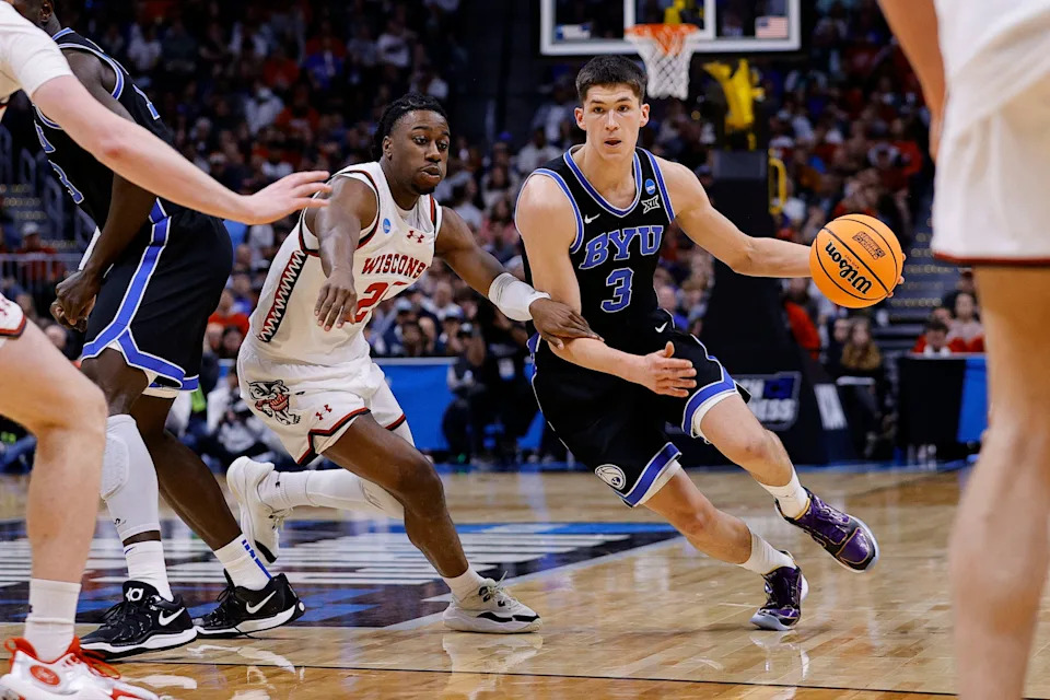 Mar 22, 2025; Denver, CO, USA; Brigham Young Cougars guard Egor Demin (3) dribbles the ball past Wisconsin Badgers guard John Blackwell (25) during the second half in the second round of the NCAA Tournament at Ball Arena. Mandatory Credit: Isaiah J. Downing-Imagn Images