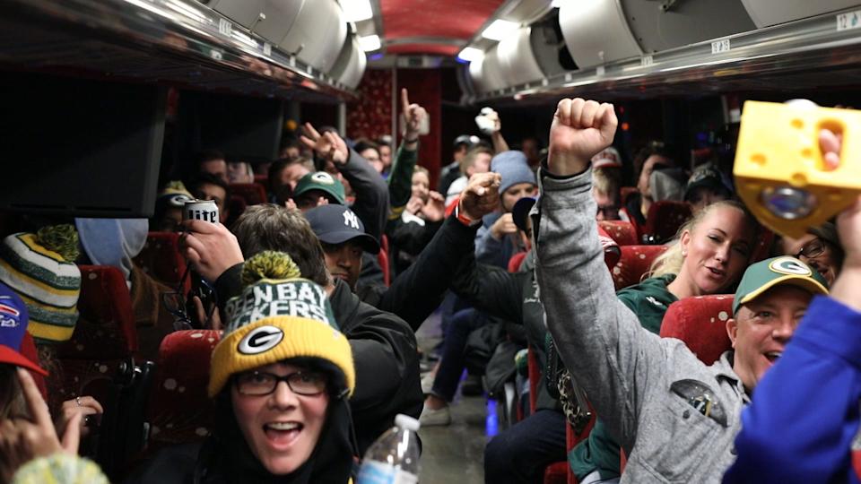 Packers fans celebrate on a shuttle bus to Lambeau Field from the Milwaukee Brat House. The bar is one of a handful in the city that have regular shuttles to Lambeau Field.