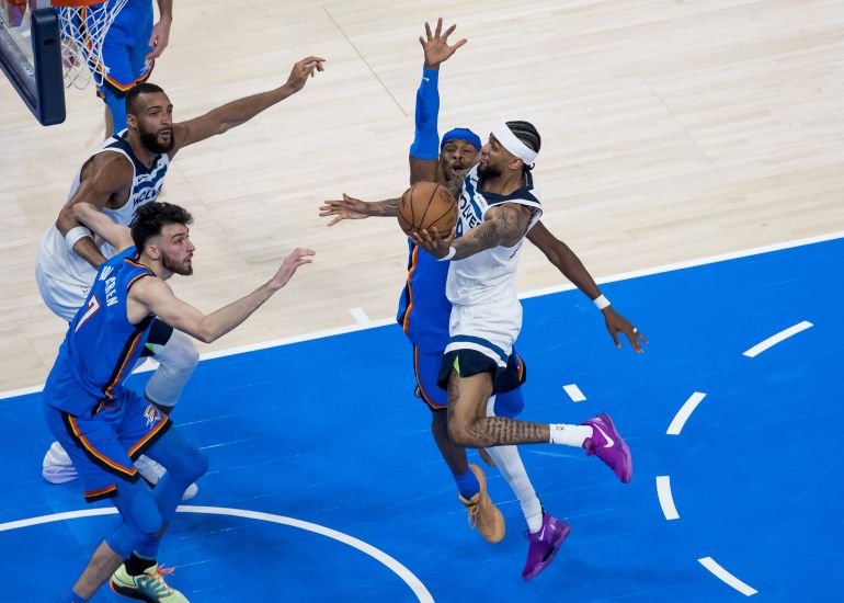 Minnesota Timberwolves guard Nickeil Alexander-Walker shoots against Oklahoma City Thunder guard Shai Gilgeous-Alexander and forward Chet Holmgren