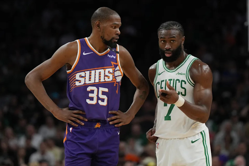 Mar 26, 2025; Phoenix, Arizona, USA; Phoenix Suns forward Kevin Durant (35) and Boston Celtics guard Jaylen Brown (7) talk during the second half at Footprint Center.© Rick Scuteri-Imagn Images