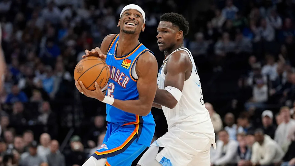 Oklahoma City Thunder guard Shai Gilgeous-Alexander (2) works toward the basket as Minnesota Timberwolves guard Anthony Edwards (5) defends during the second half of an NBA basketball game, Thursday, Feb. 13, 2025, in Minneapolis. (AP Photo/Abbie Parr)