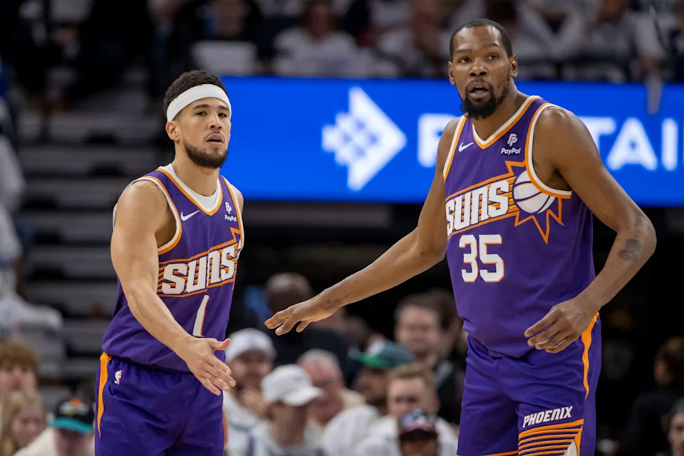 Apr 20, 2024; Minneapolis, Minnesota, USA; Phoenix Suns guard Devin Booker (1) shakes hands with forward Kevin Durant (35) against the Minnesota Timberwolves in the first half during game one of the first round for the 2024 NBA playoffs at Target Center.© Jesse Johnson-USA TODAY Sports