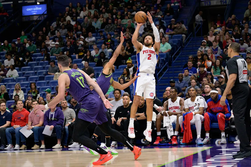 Mar 17, 2025; New Orleans, Louisiana, USA; Detroit Pistons guard Cade Cunningham (2) shoots against New Orleans Pelicans guard CJ McCollum (3) during the first half at Smoothie King Center. © Matthew Hinton-Imagn Images
