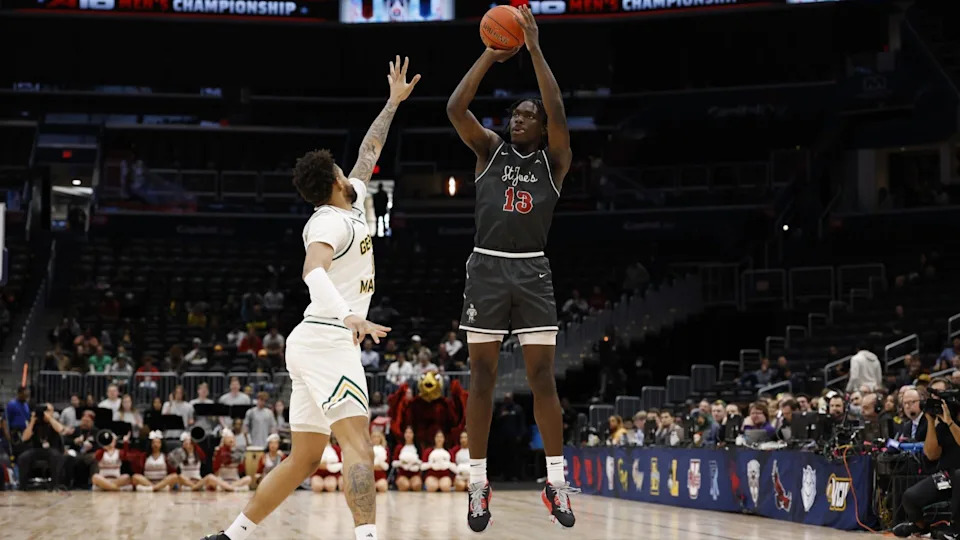 Mar 15, 2025; Washington, D.C., USA; Saint Joseph's Hawks forward Rasheer Fleming (13) shoots the ball over George Mason forward Shawn Simmons II (10) in the first half at Capital One Arena.