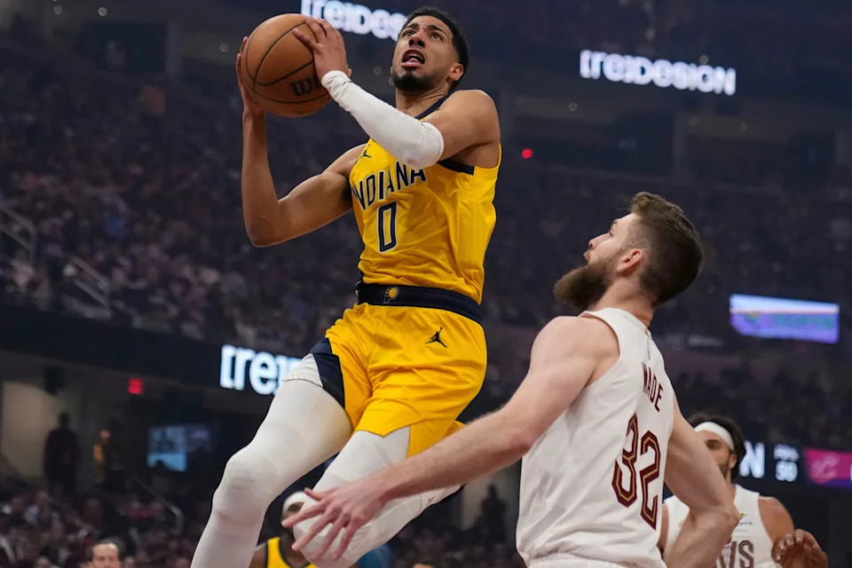 Indiana Pacers' Tyrese Haliburton (0) goes to the basket in front of Cleveland Cavaliers' Dean Wade (32) in the first half during Game 1 in the Eastern Conference semifinals of the NBA basketball playoffs Sunday, May 4, 2025, in Cleveland. (AP Photo/Sue Ogrocki)