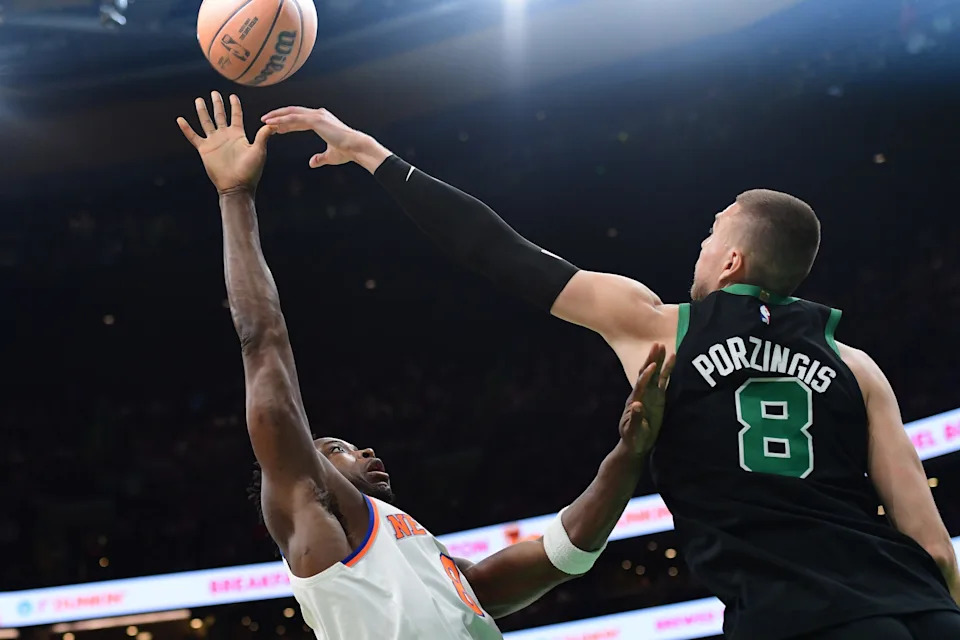 May 14, 2025; Boston, Massachusetts, USA; New York Knicks forward OG Anunoby (8) shoots the ball over Boston Celtics center Kristaps Porzingis (8) in the first half during game five of the second round for the 2025 NBA Playoffs at TD Garden. Mandatory Credit: Bob DeChiara-Imagn Images