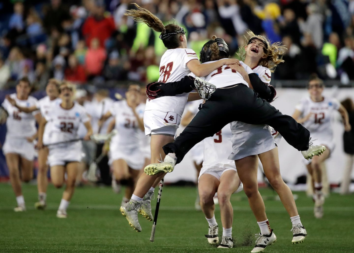 In this 2017 photo, BC goalie Lauren Daly jumps to hug teammates Brooke Troy and Carly Bell after they defeated Navy in the NCAA semifinal.