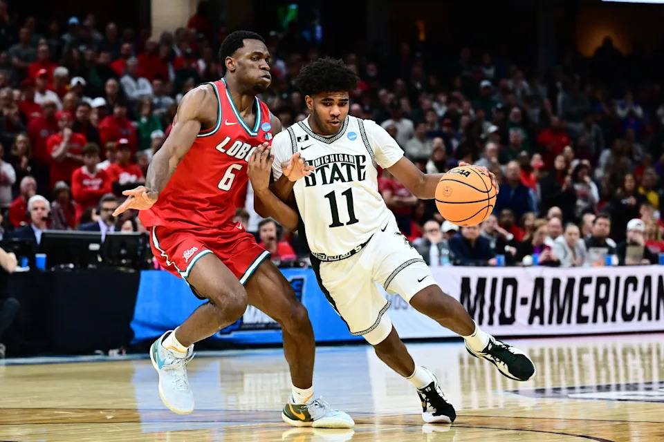 Mar 23, 2025; Cleveland, OH, USA; Michigan State Spartans guard Jase Richardson (11) dribbles defended by New Mexico Lobos forward Atiki Ally Atiki (6) in the second half during the NCAA Tournament Second Round at Rocket Arena. Mandatory Credit: Ken Blaze-Imagn Images