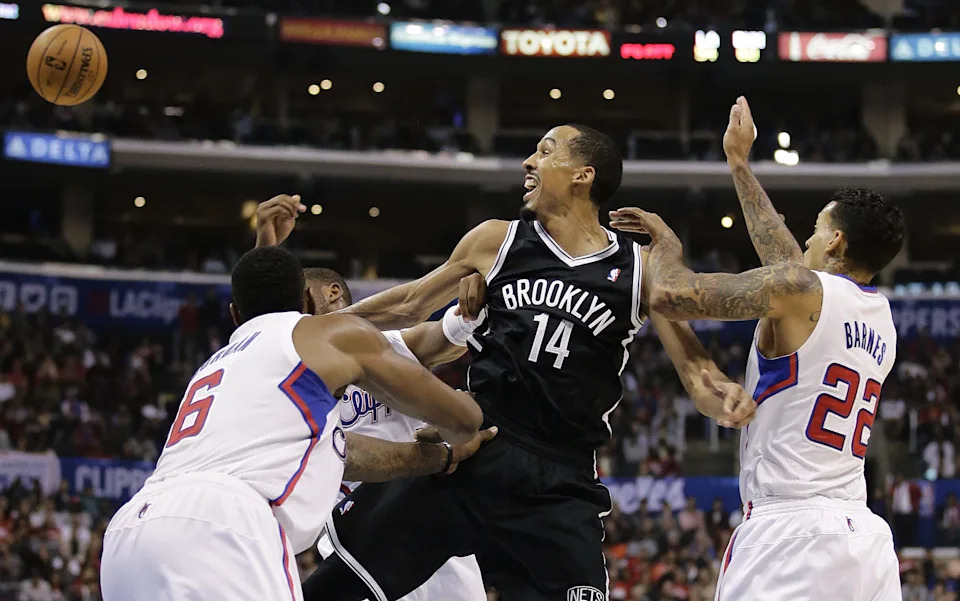 Brooklyn Nets' Shaun Livingston, center, passes the ball as he is defended by Los Angeles Clippers' DeAndre Jordan, left, and Matt Barnes during the second half of an NBA basketball game on Saturday, Nov. 16, 2013, in Los Angeles.