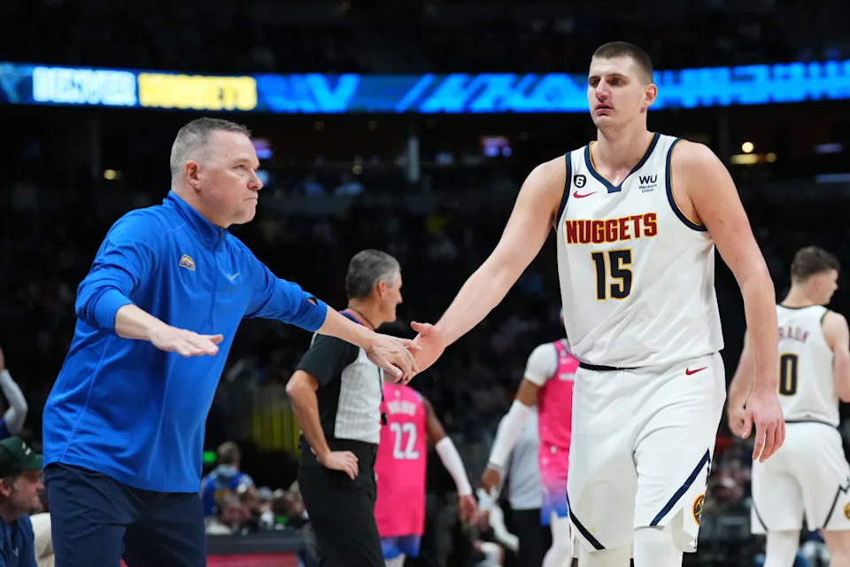 Denver Nuggets head coach Michael Malone congratulates center Nikola Jokic (15) in the fourth quarter against the Washington Wizards at Ball Arena.Ron Chenoy-Imagn Images