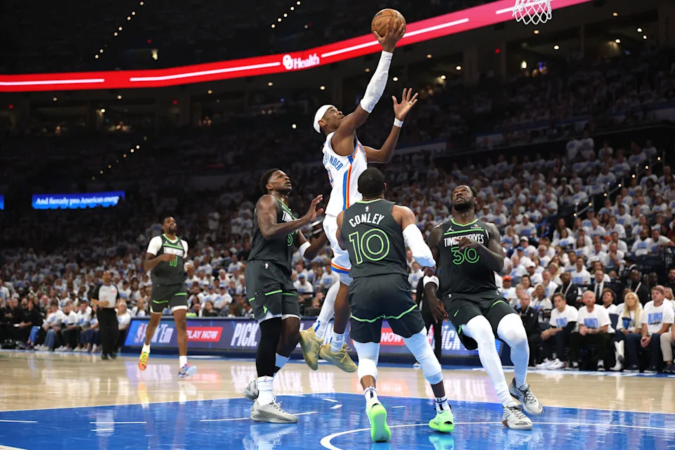 OKLAHOMA CITY, OKLAHOMA - MAY 20: Shai Gilgeous-Alexander #2 of the Oklahoma City Thunder drives to the basket against Mike Conley #10 of the Minnesota Timberwolves during the second quarter in Game One of the Western Conference Finals of the 2025 NBA Playoffs at Paycom Center on May 20, 2025 in Oklahoma City, Oklahoma. NOTE TO USER: User expressly acknowledges and agrees that, by downloading and or using this photograph, User is consenting to the terms and conditions of the Getty Images License Agreement. (Photo by Matthew Stockman/Getty Images)
