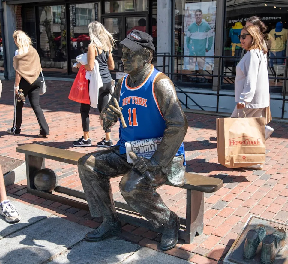 The statue of Red Auerbach wearing a New York Knicks jersey, outside Quincy Market at Faneuil Hall. David McGlynn