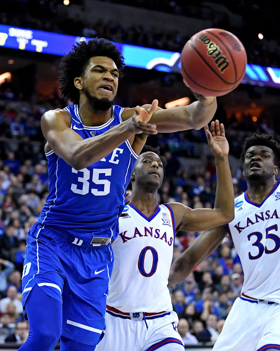 Duke Blue Devils forward Marvin Bagley III and Kansas Jayhawks guard Marcus Garrett go for a loose ball.