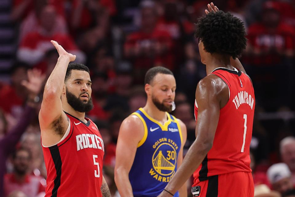 HOUSTON, TEXAS - APRIL 30: Fred VanVleet #5 and Amen Thompson #1 of the Houston Rockets high five in front of Stephen Curry #30 of the Golden State Warriors during the third quarter in Game Five of the Western Conference First Round NBA Playoffs at Toyota Center on April 30, 2025 in Houston, Texas. NOTE TO USER: User expressly acknowledges and agrees that, by downloading and or using this photograph, User is consenting to the terms and conditions of the Getty Images License Agreement. (Photo by Alex Slitz/Getty Images)
