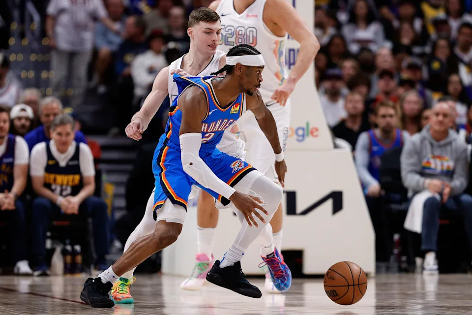 May 15, 2025; Denver, Colorado, USA; Oklahoma City Thunder guard Shai Gilgeous-Alexander (2) controls the ball as Denver Nuggets guard Christian Braun (0) guards in the third quarter during game six of the second round for the 2025 NBA Playoffs at Ball Arena. Mandatory Credit: Isaiah J. Downing-Imagn Images