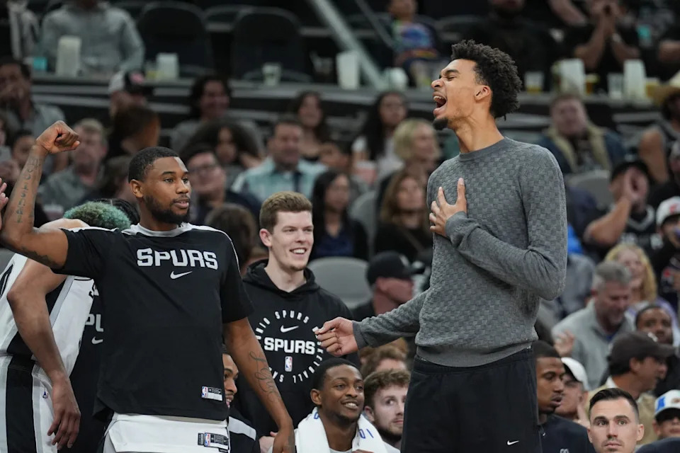 Mar 4, 2025; San Antonio, Texas, USA; San Antonio Spurs guard Blake Wesley (14) and San Antonio Spurs center Victor Wembanyama (1) celebrate on the sideline in the second half against the Brooklyn Nets at Frost Bank Center. © Daniel Dunn-Imagn Images
